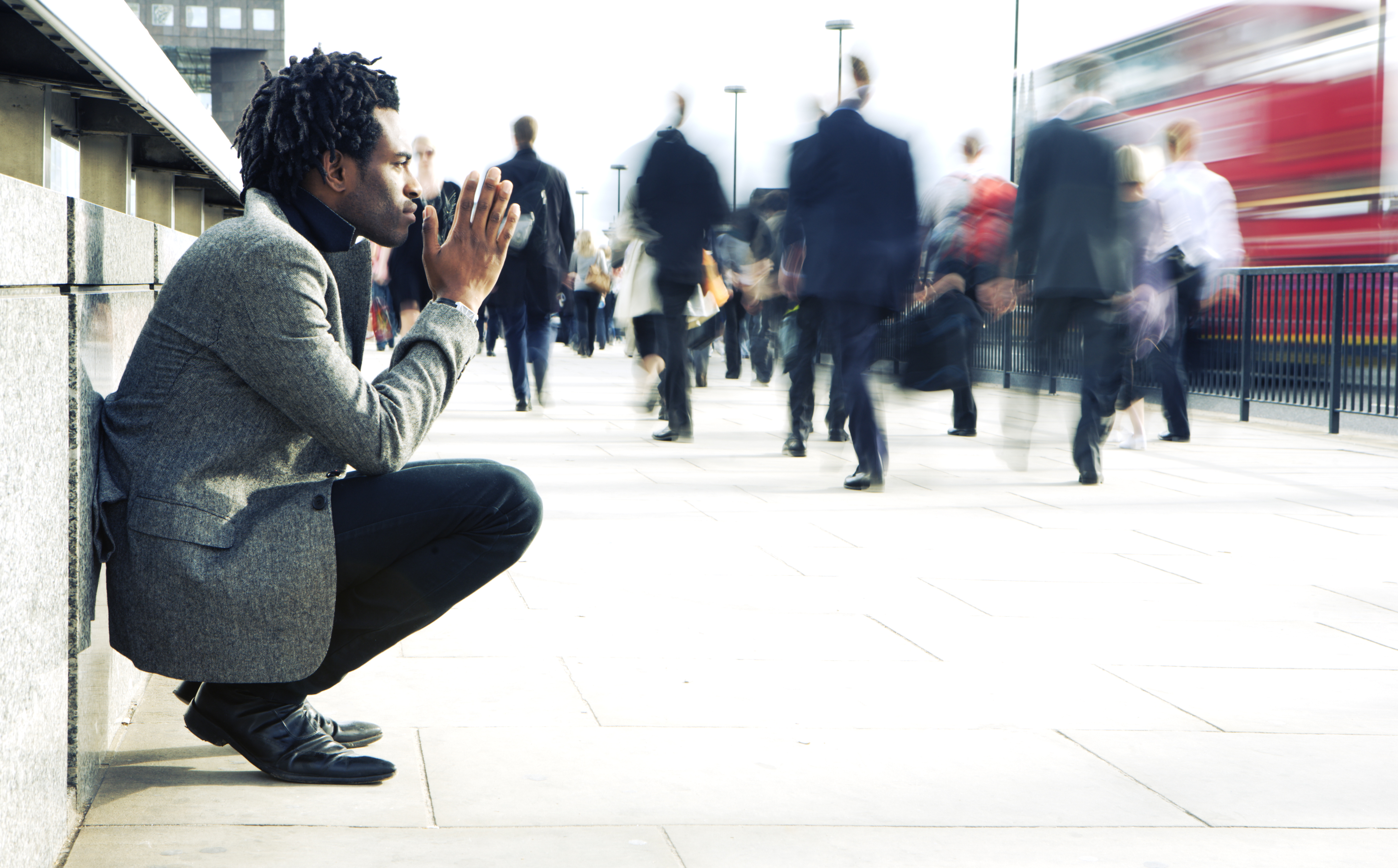 Contemplation from a solitary character contrasting against a hurried world