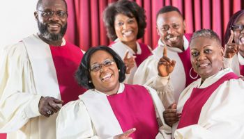 Mature black women and men singing in church choir
