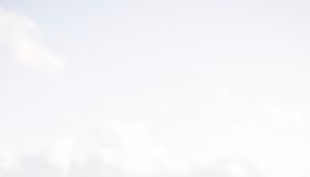 Open Bible on wooden balcony with mountain view and soft natural light.