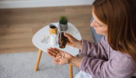 Sick woman taking pills at home