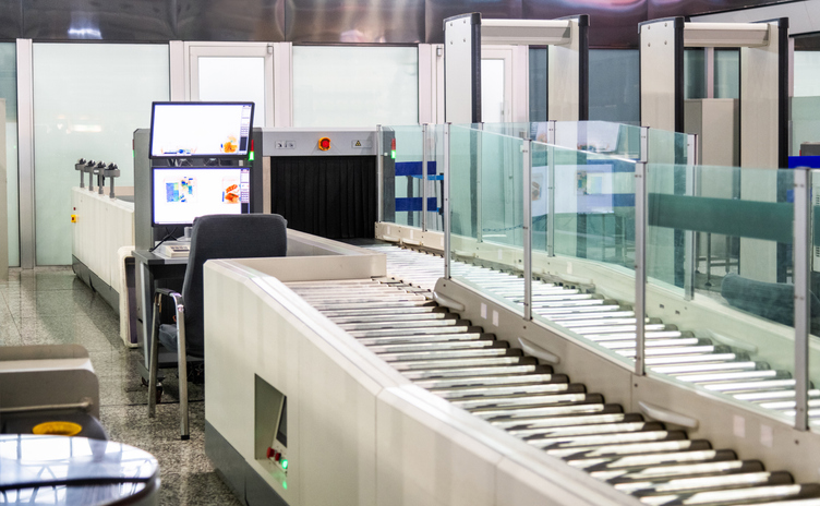 Luggage security x ray machine and computer monitor at airport terminal