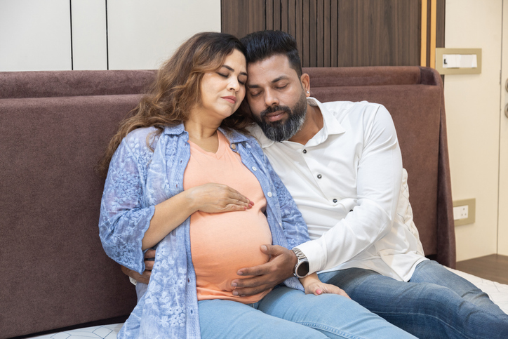 Young indian pregnant couple expecting baby, pregnancy support care