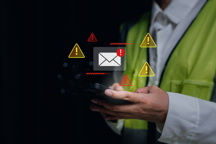 Spam Email. Cybersecurity alert, engineer using smartphone with warning notification icons, digital communication risk and data protection concept