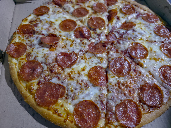 Hot, traditional pepperoni pizza ready to eat