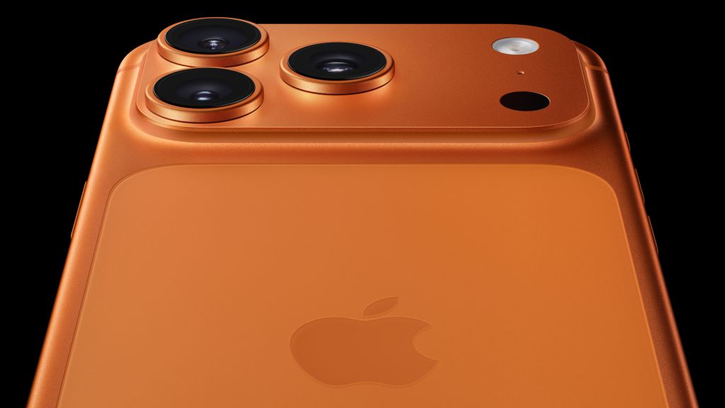 An orange iPhone 14 Pro with a triple-lens camera system and Apple logo.